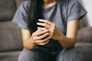 woman removing wedding ring